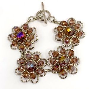 Silver tone open work and iridescent purple glass bead flower link bracelet